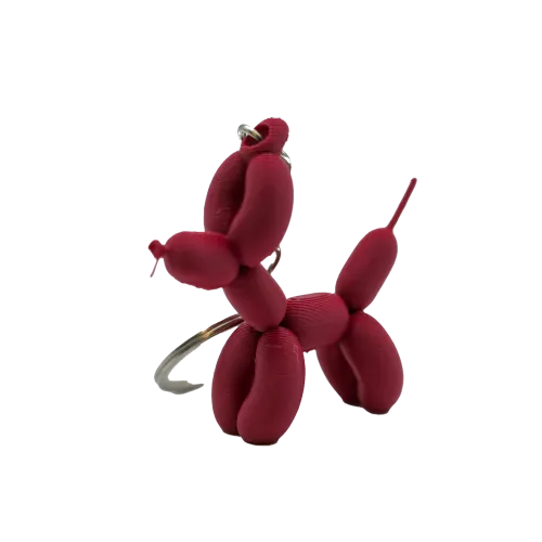Sleutelhanger in de vorm van een roze ballonhondje.