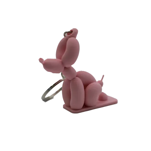 Roze ballondier sleutelhanger in de vorm van een hond.
